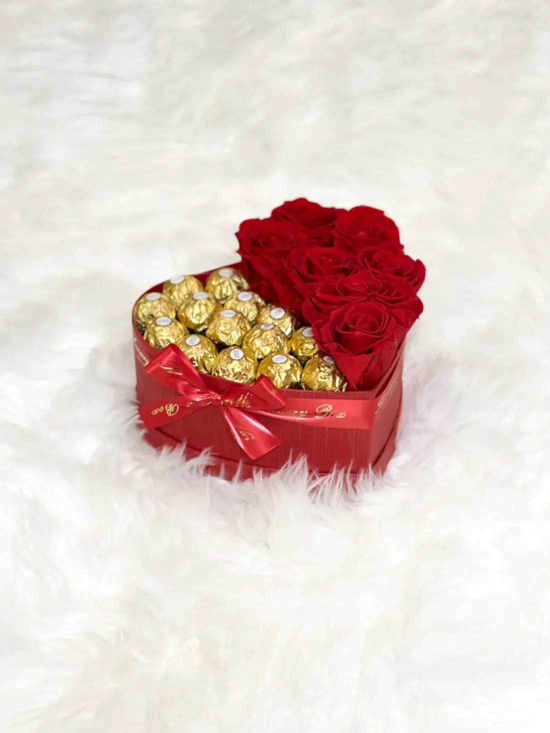 Red infinity roses and chocolate for Valentine's Day delivery in heart shaped box