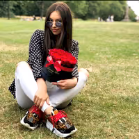 woman smiling with gift for her, red eternity roses in black box